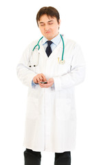 Fototapeta premium Very pleased medical doctor counting on calculator