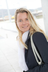 Portrait of beautiful blond woman in town