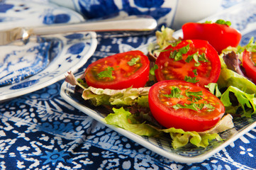 Blue crockery with fresh tomatoes