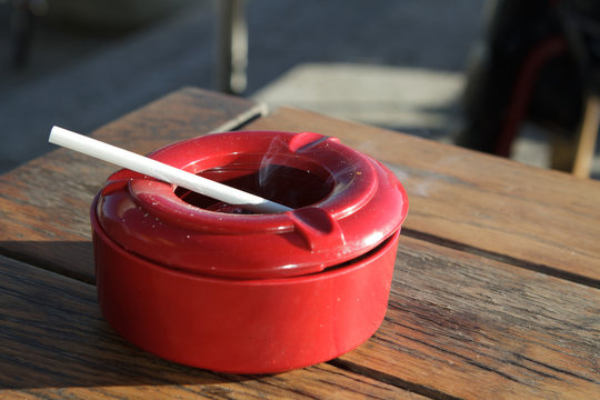 Ashtray with burning cigarette