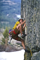 Rock climber clinging to a cliff.