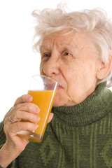 The elderly woman with a juice glass