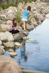 Two Girls Playing By The Water