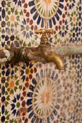 Tap on a wall of Moroccan tiles