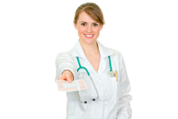 Smiling medical female doctor holding medical prescription