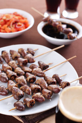 Grilled chicken hearts on skewers