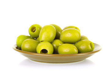 Green olives on the plate  isolated on white