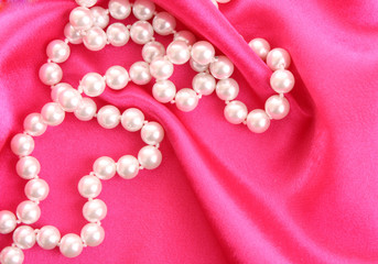 Smooth elegant red silk background with pearls