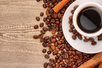 coffee with cinnamon on wooden texture background
