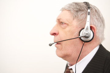 Old businessman with headset isolated over white background