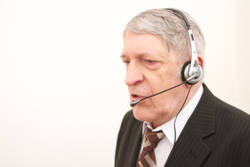 Old businessman with headset isolated over white background