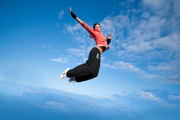 Fototapeta na wymiar sport woman jumping and fly over sky