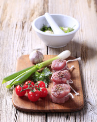 Raw pork tenderloin and vegetables