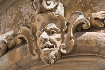 Stone face on wall.