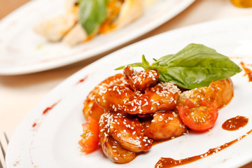 portion of sesame chicken served on a white plate
