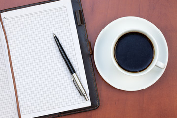 Obraz na płótnie Canvas Coffee cup, notebook and pen