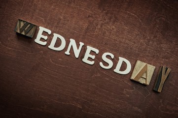 The word wednesday written on wooden background