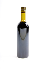 close-up of red wine bottle over white