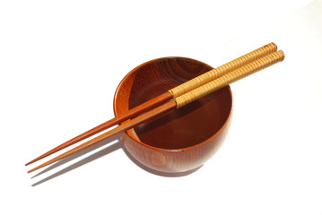 Chopsticks with wooden bowl isolated on white