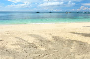 Fototapeta na wymiar Beautiful beach with palm trees shadow