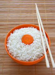 Rice and a slice of carrot as a flag of Japan.
