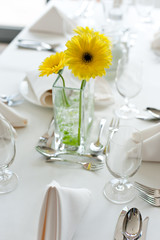 Table in restaurant with gerbera flowers