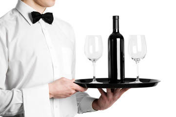Waiter hands with wine bottle and stemware on tray