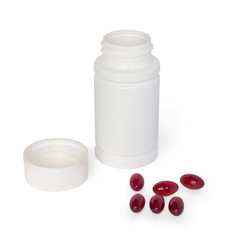 White medicine bottle with brown pills scattered