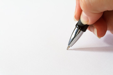 hand with pen over blank paper
