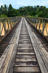 Old bridge over a brown river