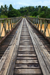 Fototapeta na wymiar Old bridge over a brown river