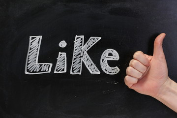 Thumbs up sign for the word Like on a Blackboard
