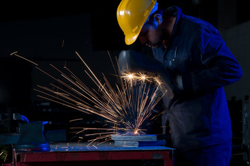Worker making sparks while welding steel.