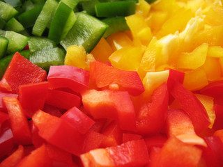 Yellow, red and green peppers Bulgarian. Slicing. Cubes