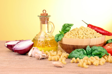 spaghetti with olive oil,garlic, onion  and basil on a yellow ba