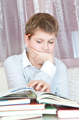 pupil sits at  table with books