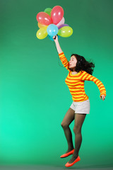 Fototapeta premium Jumping happy girl with balloons