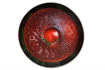 A strawberry in a metal bowl