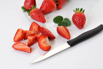 cutting strawberries on white background - 31330880