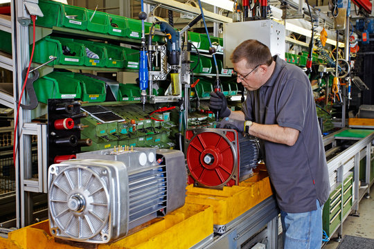 skilled industrial worker, mounting electric motors