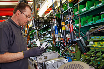 skilled industrial worker checking the routing slip