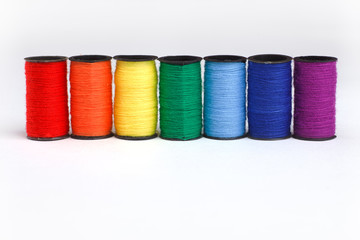 Threads of main spectrum colors on white background