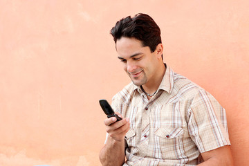 happy hispanic man with cell or mobile phone