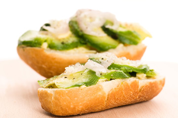 Sandwich with avocado on a wooden board