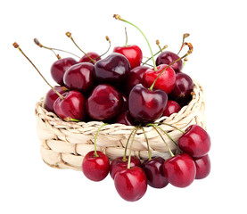 sweet cherries in a basket isolated on white.