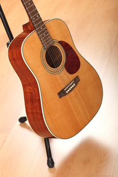 Brown guitar on neutral background