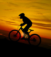 Fototapeta na wymiar Mountain biker at sunset