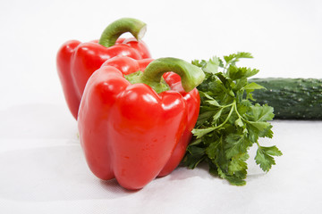 Vegetables - red pepper, parsley, cucumber on a white background