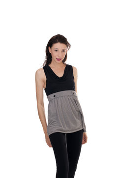 Skinny young woman standing short skirt leggings