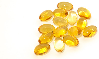 Oil vitamins yellow capsule on the white background